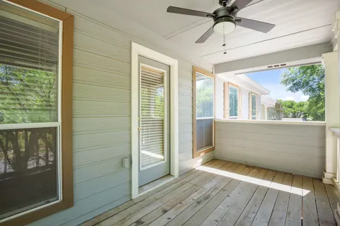 a view of a porch with wooden floor and iron stairs
