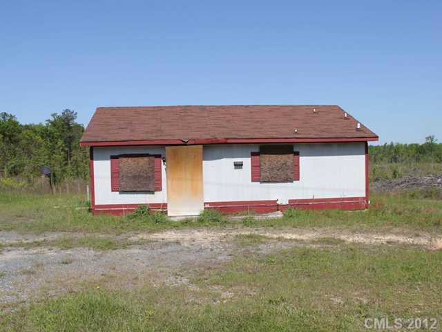 1-2 Cason Oldfield Road Morven, NC 28119 - Photo 2 of 12 a front view of a house with a yard and garage