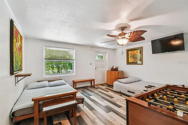 a view of a patio with table and chairs a barbeque with wooden floor and fence