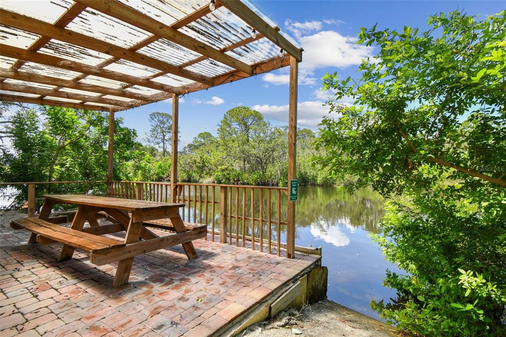 5909 Mohr Road Tampa, FL 33615 - Photo 22 of 48 a roof deck with table and chairs and potted plants with sky view