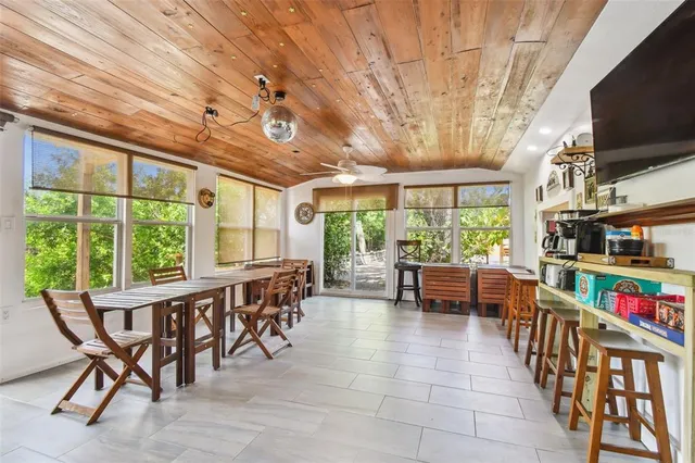 a view of a swimming pool with a lounge chair and trees