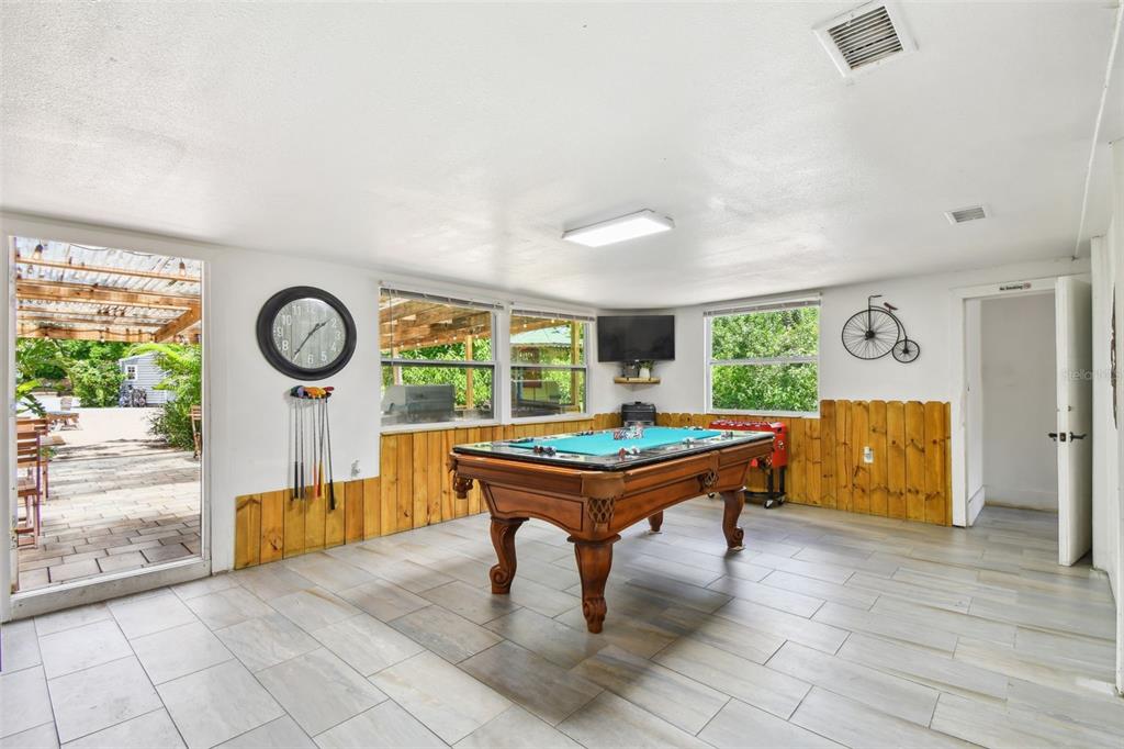 5909 Mohr Road Tampa, FL 33615 - Photo 29 of 48 a room with pool table and glass door