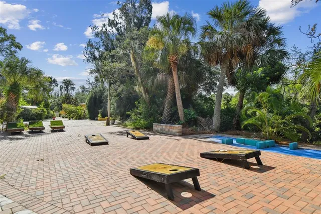 a bed sitting in a bathroom next to a shower curtain