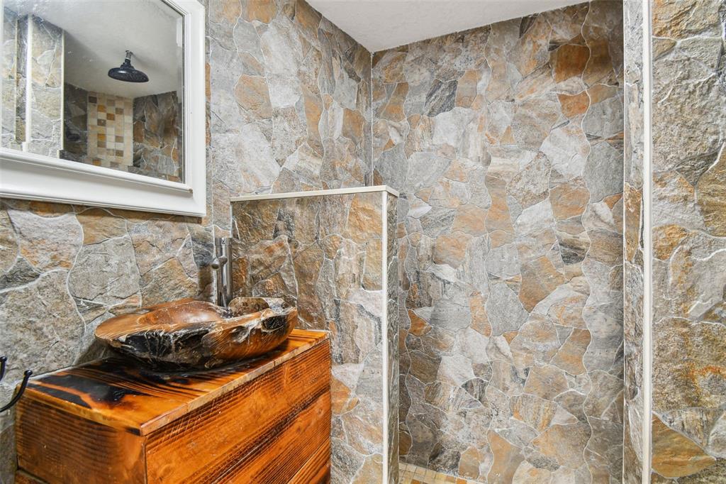 5909 Mohr Road Tampa, FL 33615 - Photo 32 of 48 a bed sitting in a bathroom next to a shower curtain