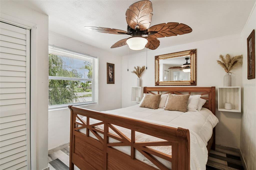 5909 Mohr Road Tampa, FL 33615 - Photo 38 of 48 a bedroom with a large bed and a chandelier