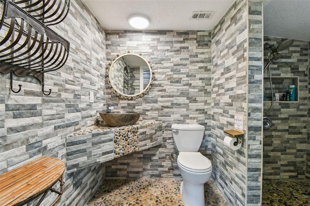 5909 Mohr Road Tampa, FL 33615 - Photo 44 of 48 a bathroom with a toilet and a shower curtain