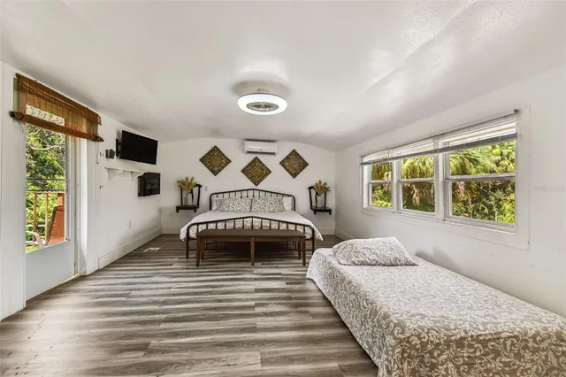 a bedroom with furniture and a large window