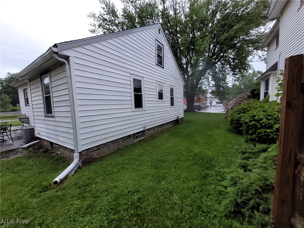 3524 State Road Ashtabula, OH 44004 - Photo 37 of 45 View of side of property featuring a yard and central AC
