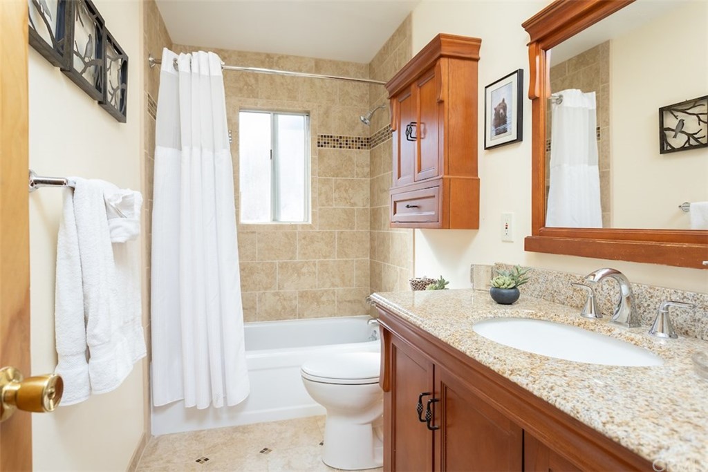 1270 Sheephorn Road Big Bear Lake, CA 92315 - Photo 14 of 25 a bathroom with a granite countertop sink a toilet and shower