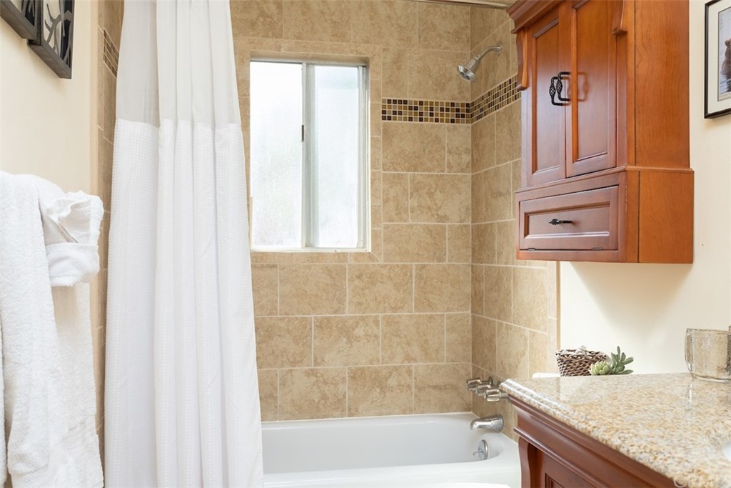 1270 Sheephorn Road Big Bear Lake, CA 92315 - Photo 16 of 25 a bathroom with a granite countertop bathtub and shower
