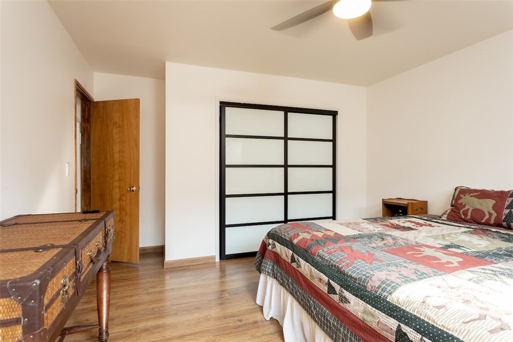 1270 Sheephorn Road Big Bear Lake, CA 92315 - Photo 18 of 25 a bedroom with a bed and a dresser with wooden floor