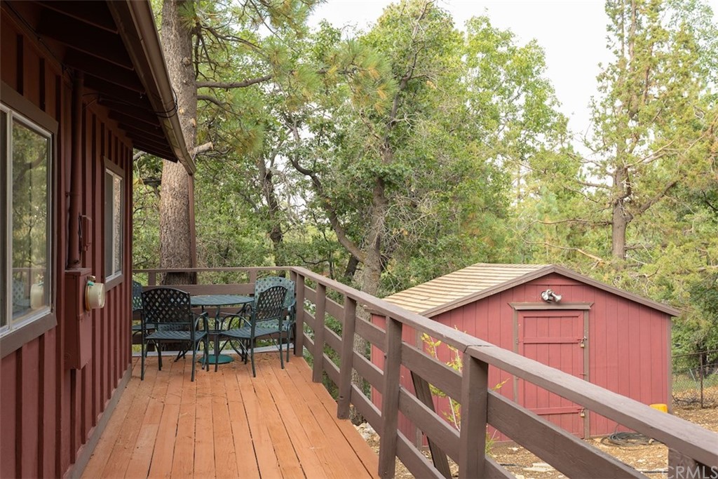 1270 Sheephorn Road Big Bear Lake, CA 92315 - Photo 21 of 25 a view of a deck with chairs and wooden fence
