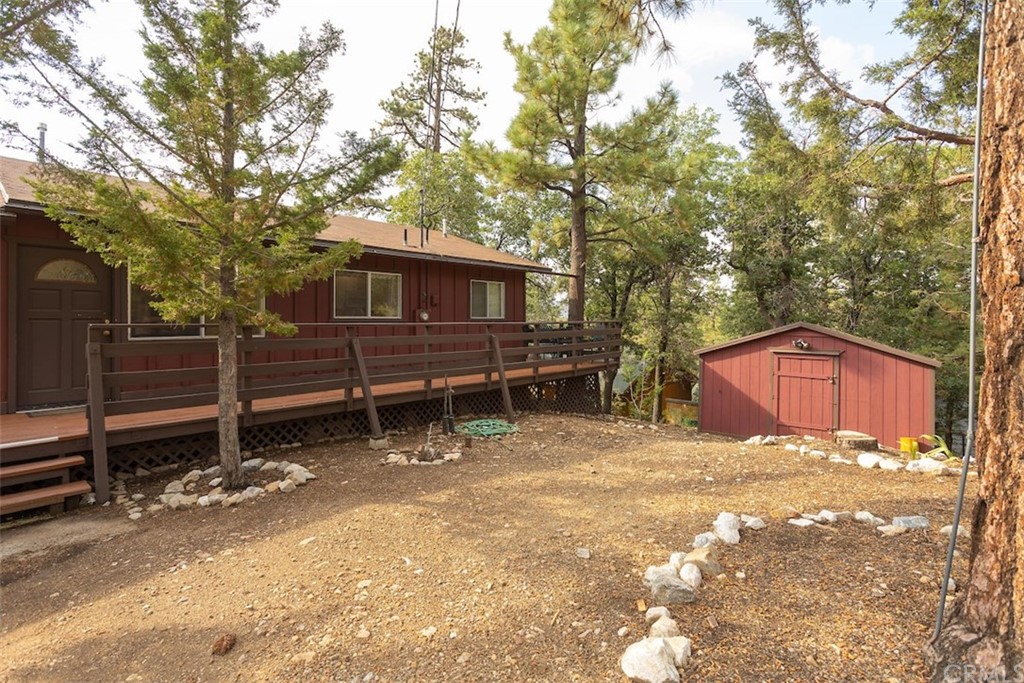 1270 Sheephorn Road Big Bear Lake, CA 92315 - Photo 22 of 25 a view of backyard with wooden fence and a large tree