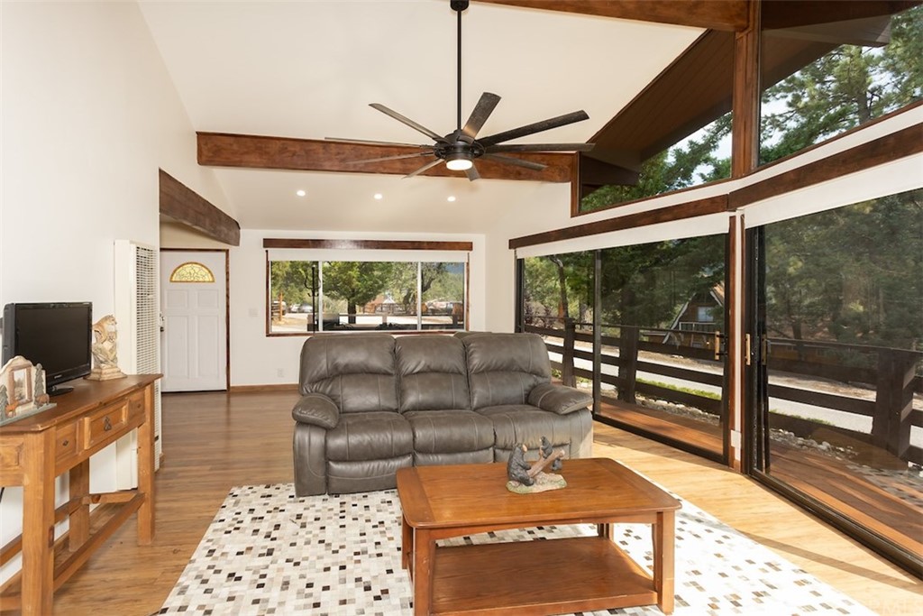 1270 Sheephorn Road Big Bear Lake, CA 92315 - Photo 3 of 25 a living room with furniture a flat screen tv and a floor to ceiling window