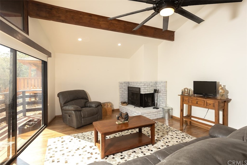1270 Sheephorn Road Big Bear Lake, CA 92315 - Photo 4 of 25 a living room with furniture a fireplace and a flat screen tv