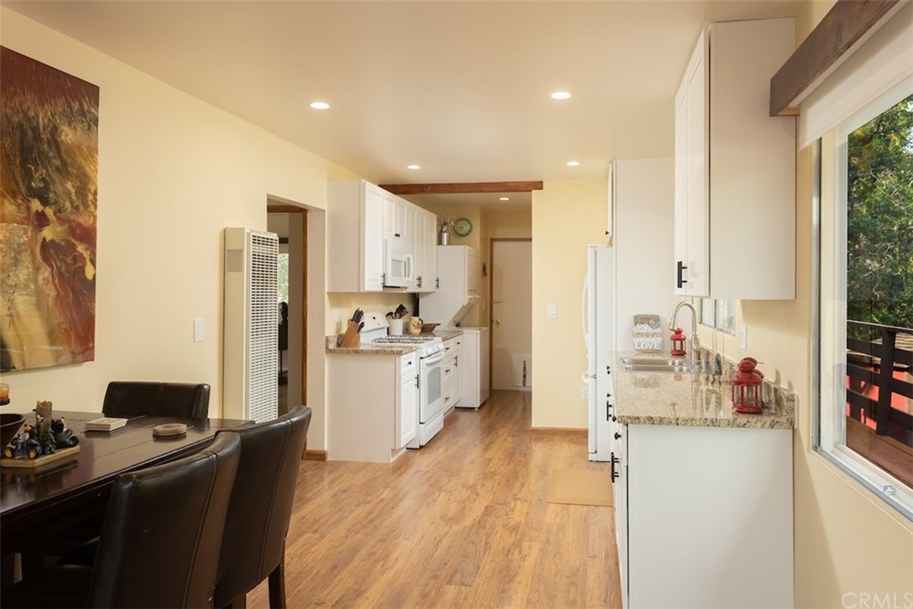 1270 Sheephorn Road Big Bear Lake, CA 92315 - Photo 7 of 25 a kitchen with refrigerator cabinets and wooden floor