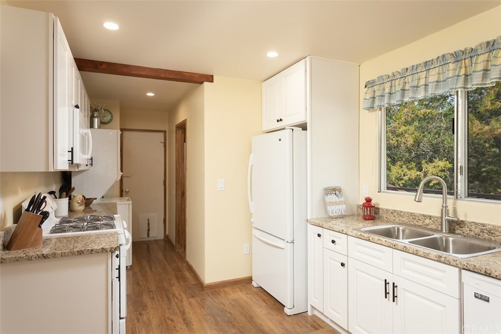 1270 Sheephorn Road Big Bear Lake, CA 92315 - Photo 9 of 25 a kitchen with granite countertop a sink and a refrigerator