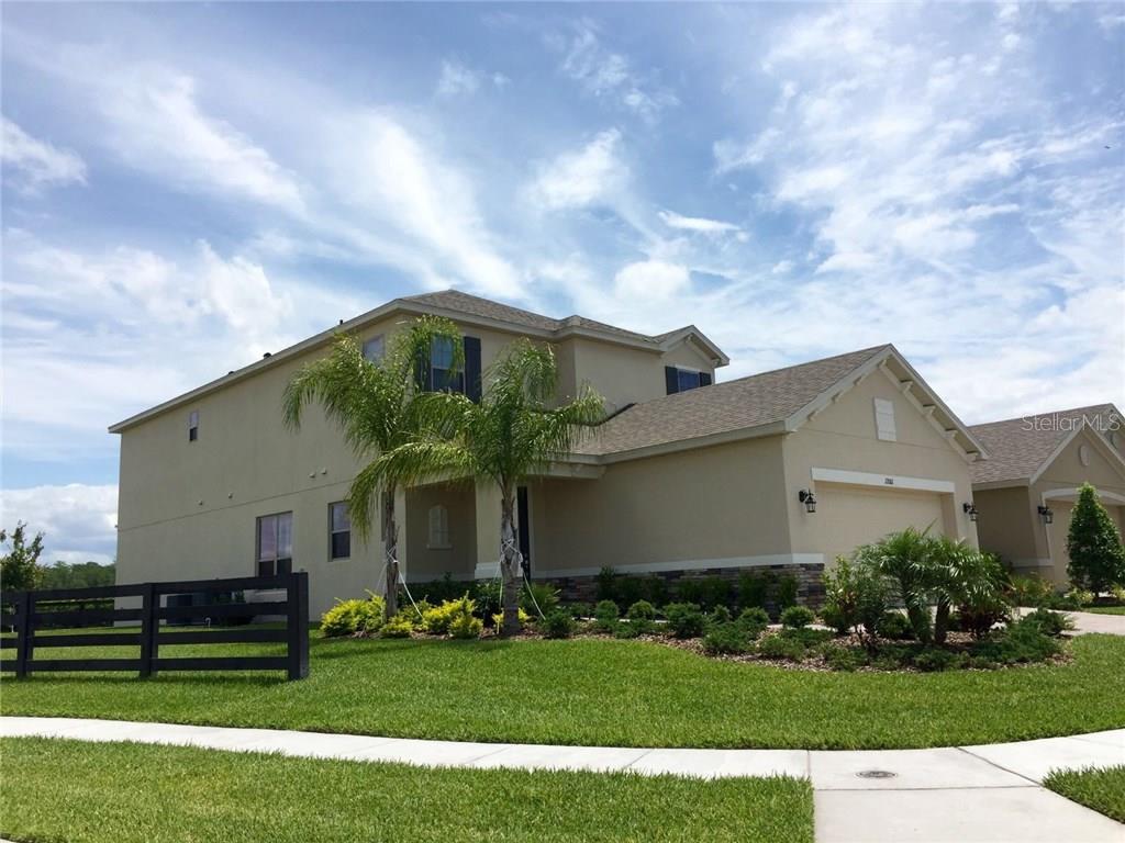 a front view of house with a garden