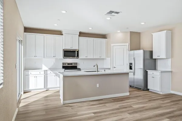 a large kitchen with cabinets and stainless steel appliances