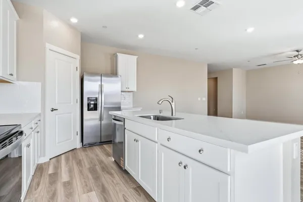 a kitchen with a sink appliances and cabinets