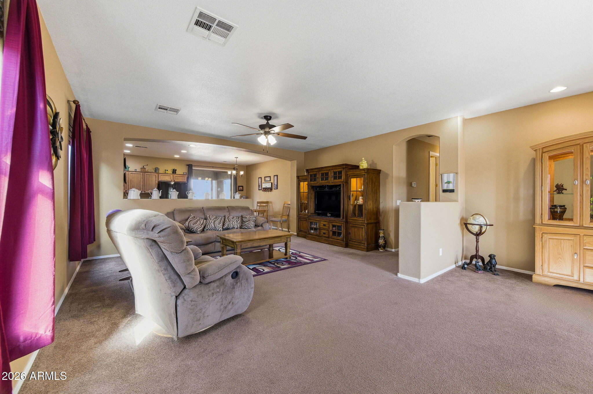 45558 West Mountain View Road Maricopa, AZ 85139 - Photo 13 of 33 a living room with furniture and a flat screen tv