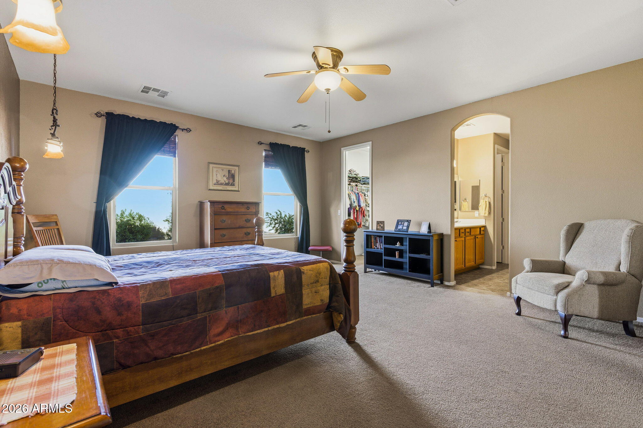 45558 West Mountain View Road Maricopa, AZ 85139 - Photo 16 of 33 a bed room with a bed and a chair