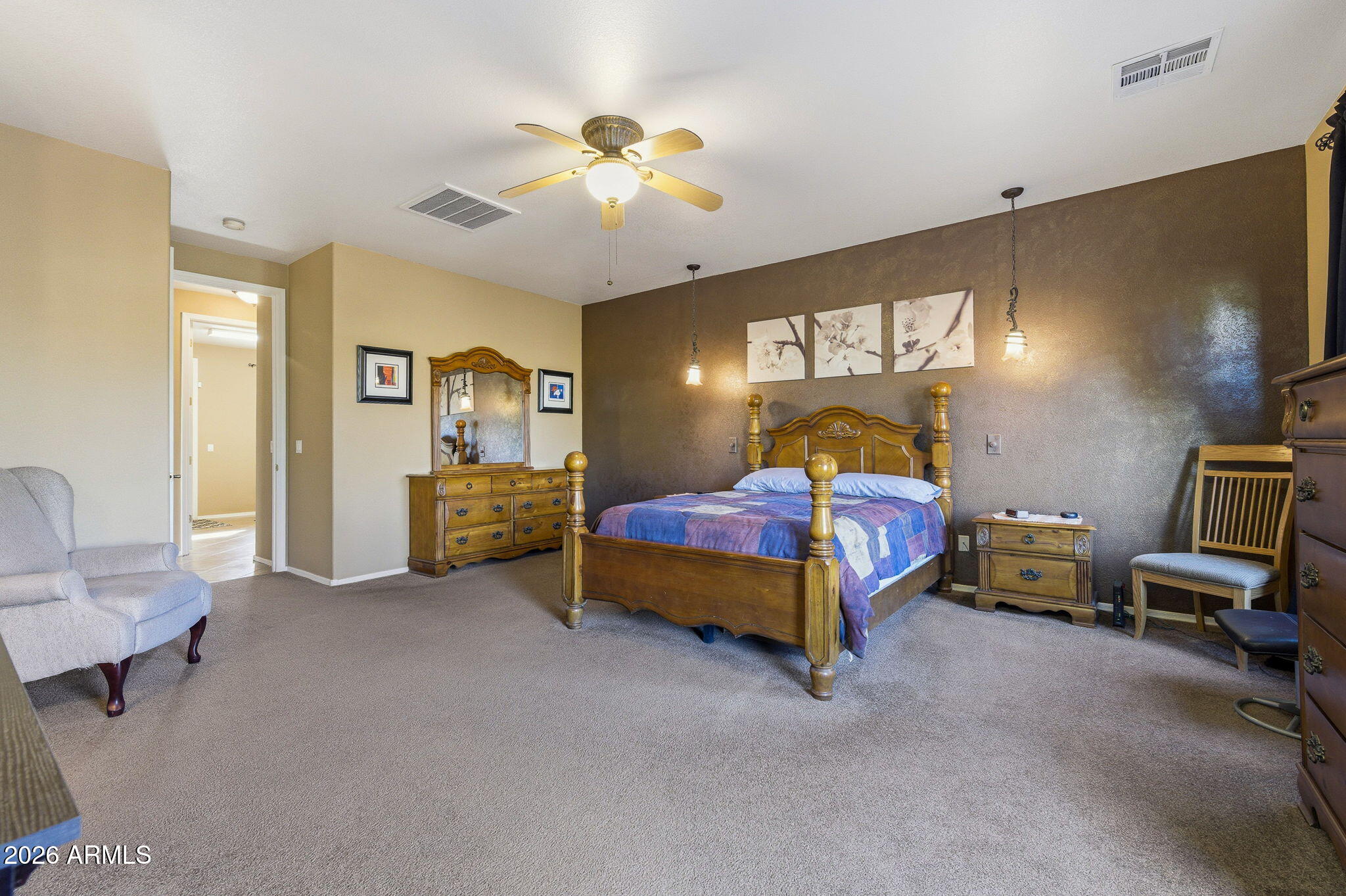 45558 West Mountain View Road Maricopa, AZ 85139 - Photo 17 of 33 a bedroom with a bed and furniture