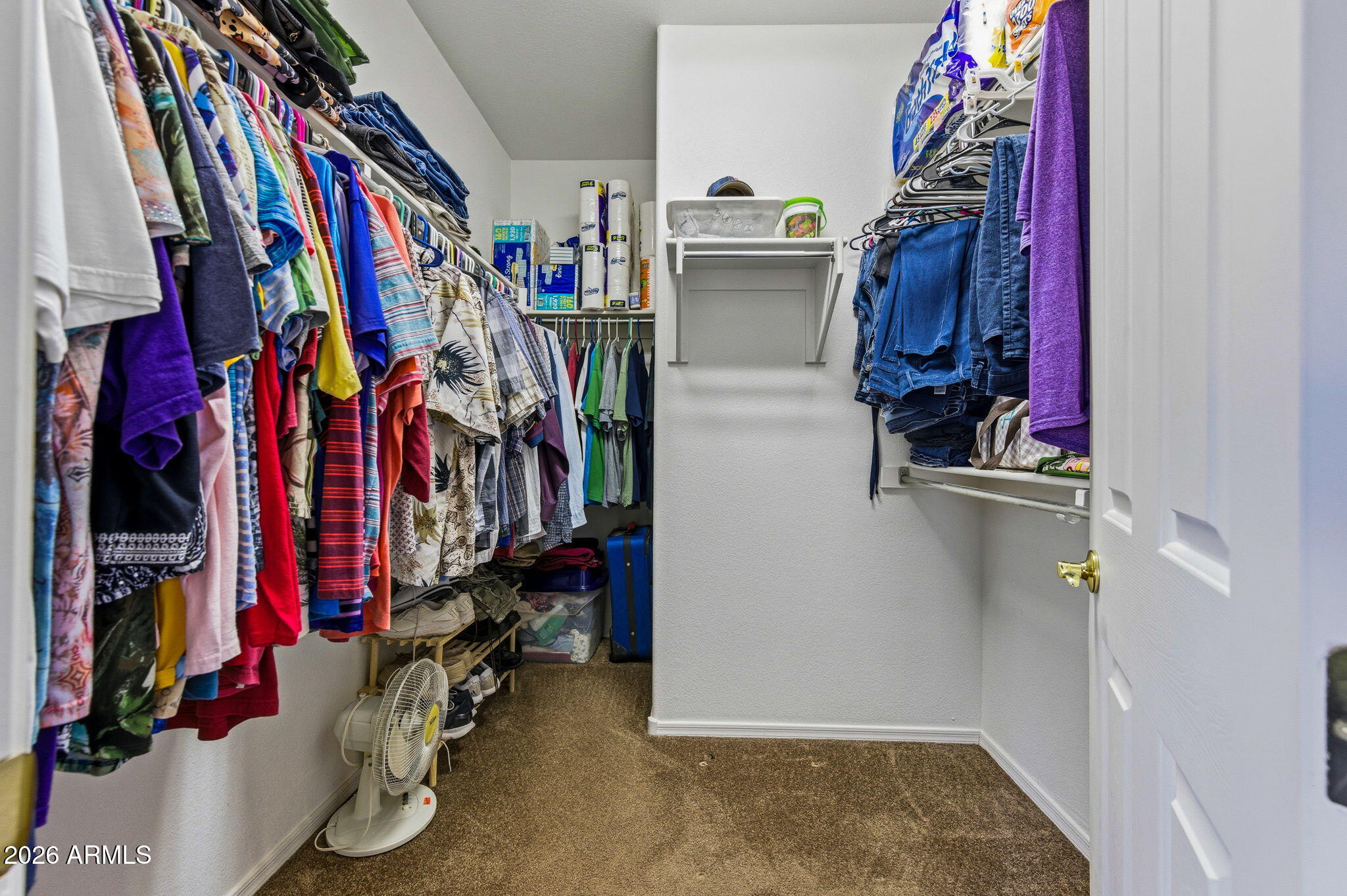 45558 West Mountain View Road Maricopa, AZ 85139 - Photo 18 of 33 a view of walk in closet with clothes and shoes