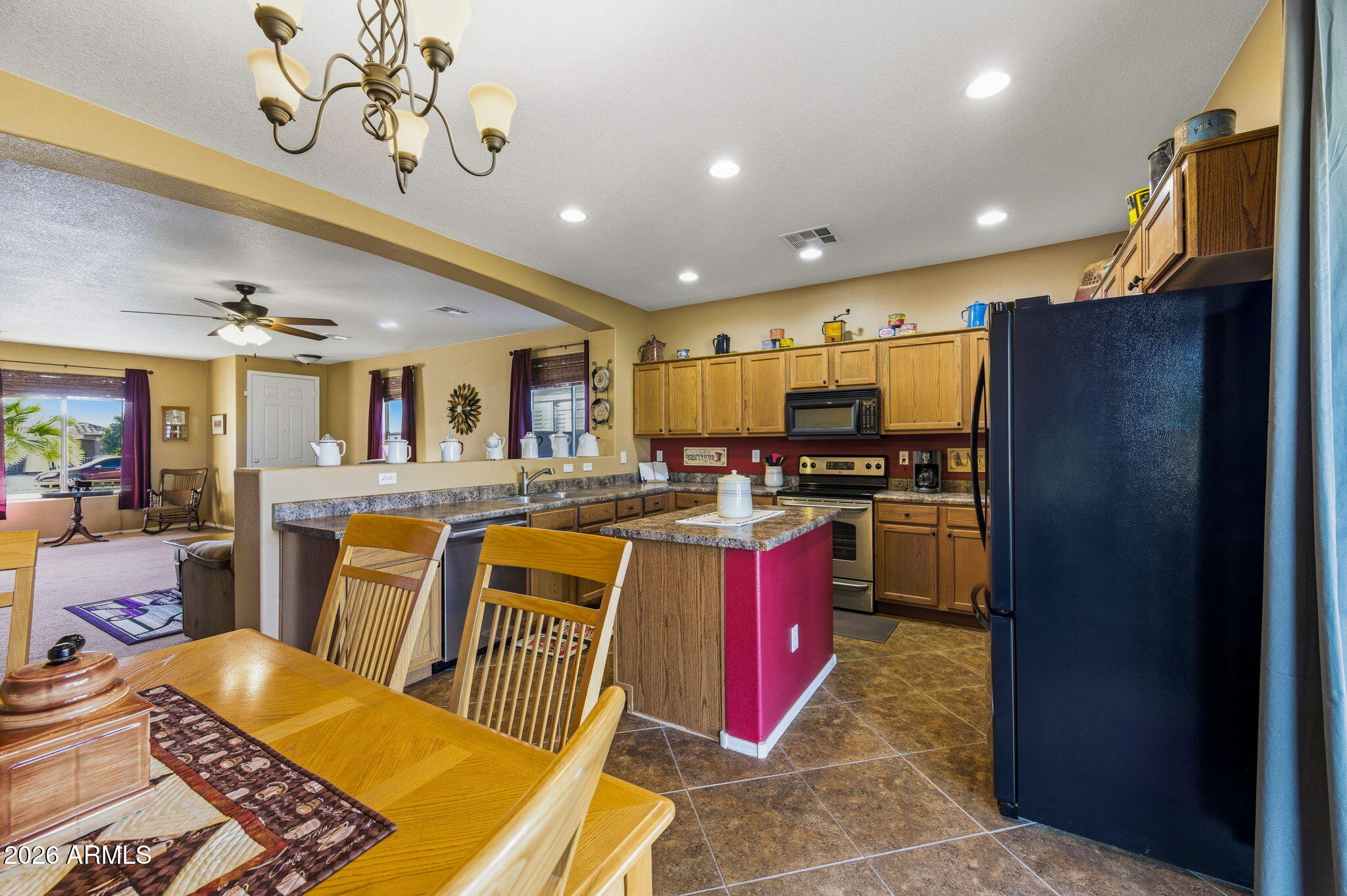 45558 West Mountain View Road Maricopa, AZ 85139 - Photo 7 of 33 a living room with stainless steel appliances kitchen island granite countertop furniture and a view of kitchen