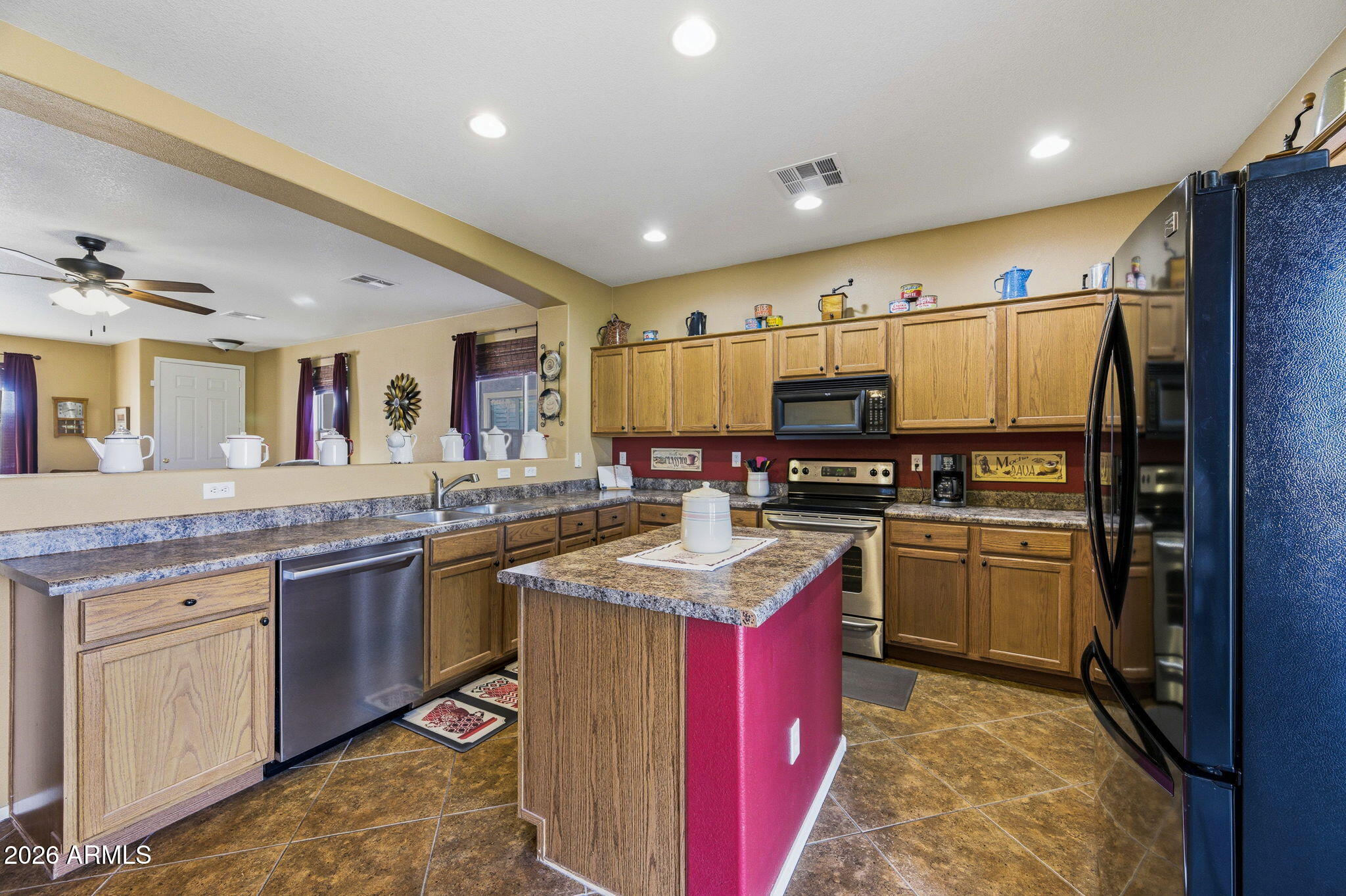 45558 West Mountain View Road Maricopa, AZ 85139 - Photo 8 of 33 a kitchen with stainless steel appliances granite countertop a sink stove and refrigerator