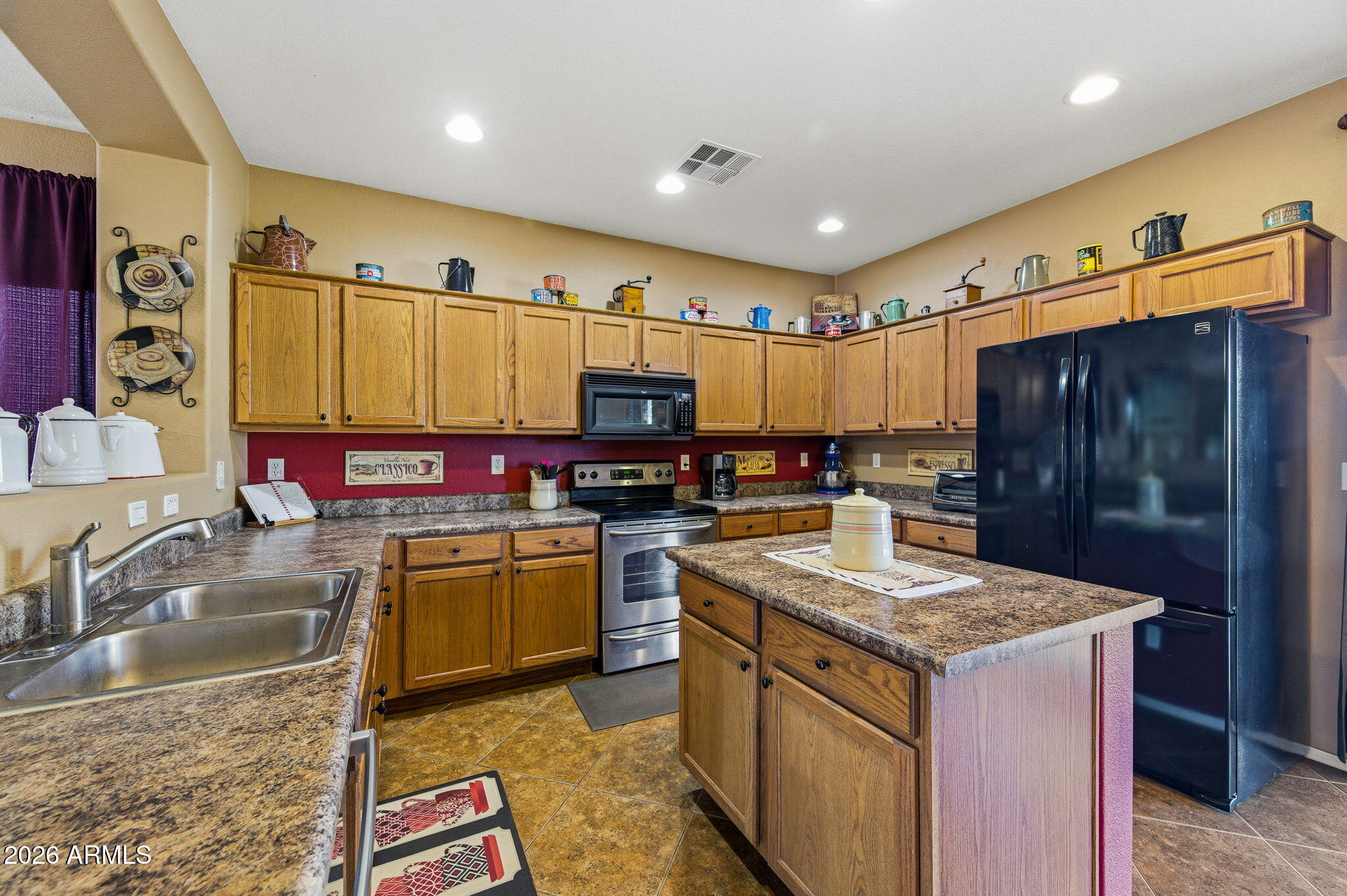 45558 West Mountain View Road Maricopa, AZ 85139 - Photo 9 of 33 a kitchen with a stove a refrigerator and a sink