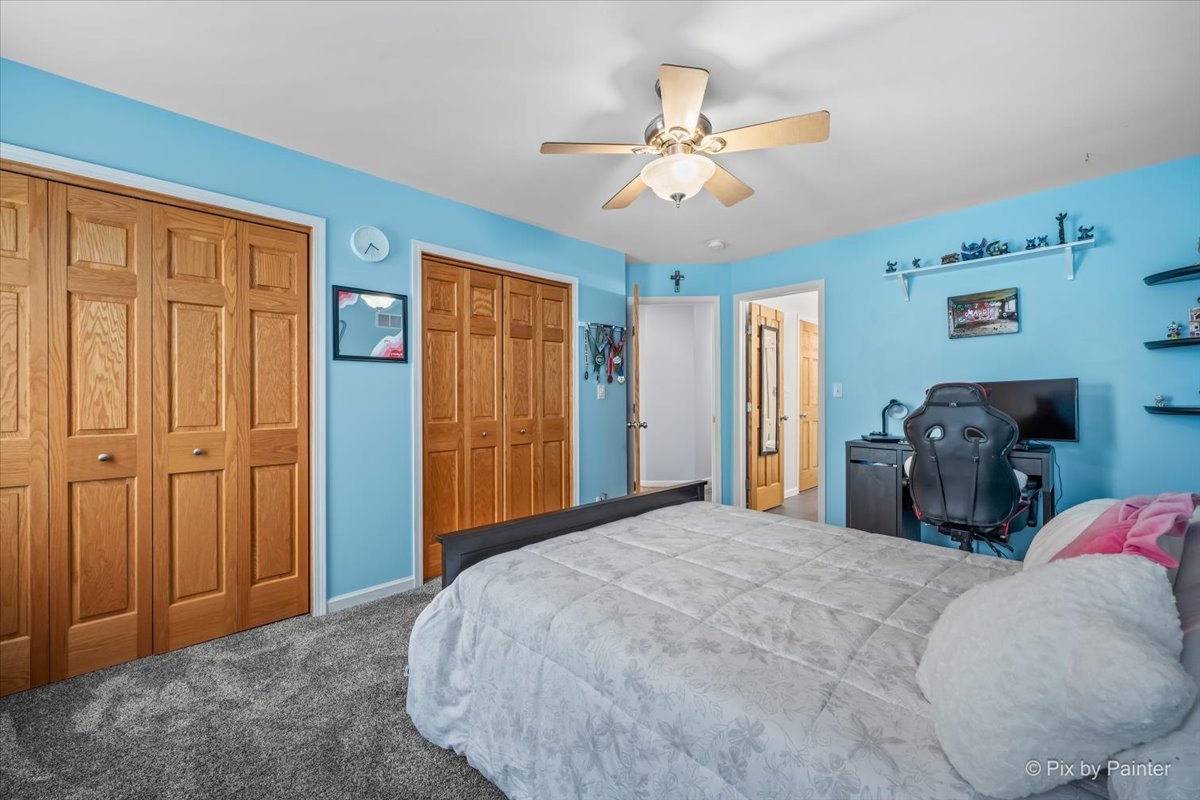 7104 Dove Way Cary, IL 60013 - Photo 41 of 82 a bedroom with a bed and a chandelier