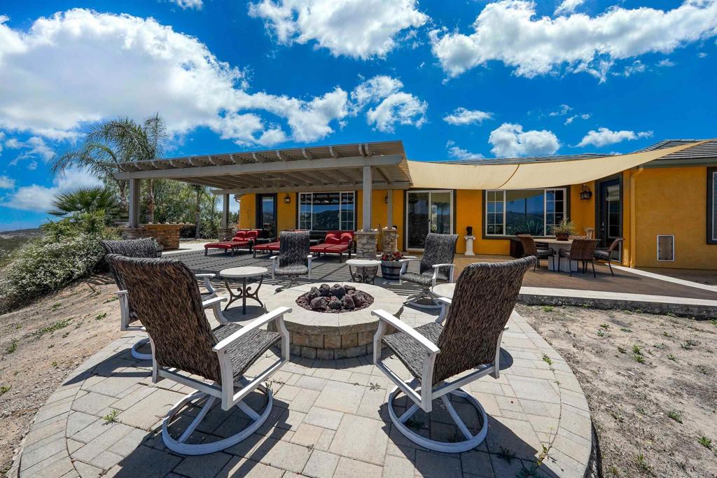 22963 Stokes Road Ramona, CA 92065 - Photo 5 of 57 a view of a patio with dining table and chairs with plants