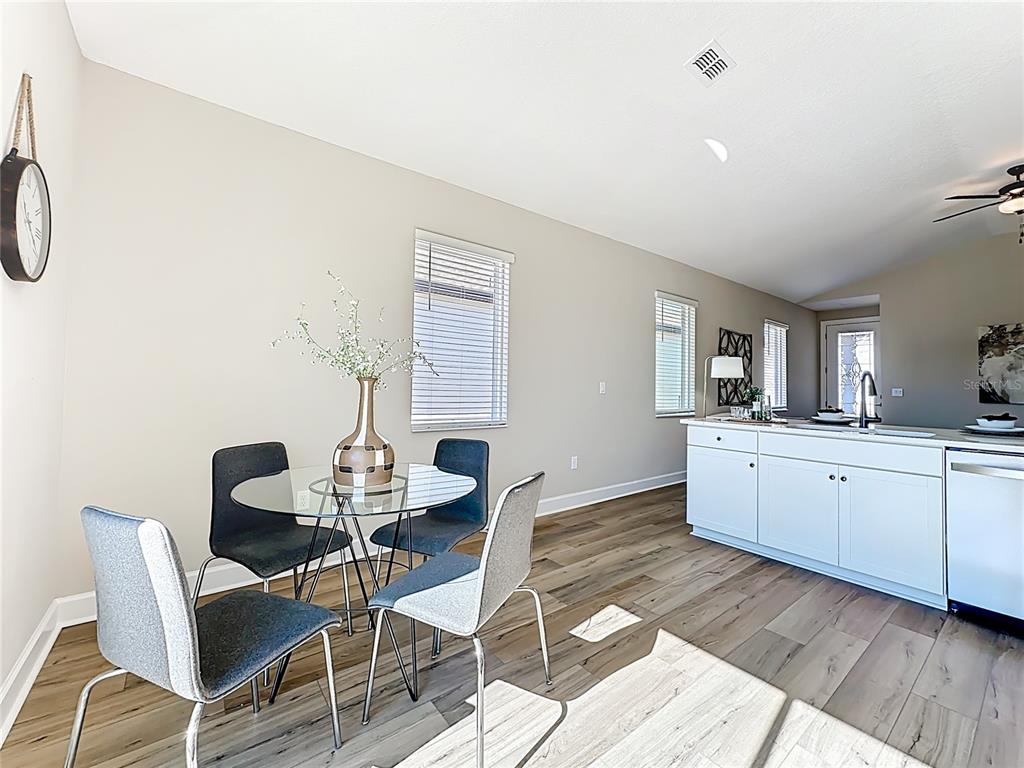 3941 Gareys Ferry Way Middleburg, FL 32068 - Photo 12 of 45 a view of a dining room with furniture and wooden floor