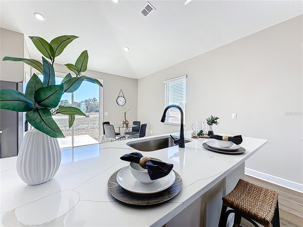 3941 Gareys Ferry Way Middleburg, FL 32068 - Photo 13 of 45 a dining room with furniture and a potted plant