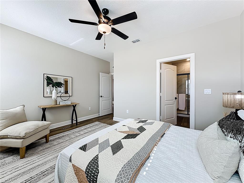 3941 Gareys Ferry Way Middleburg, FL 32068 - Photo 16 of 45 a bedroom with a bed and wooden floor