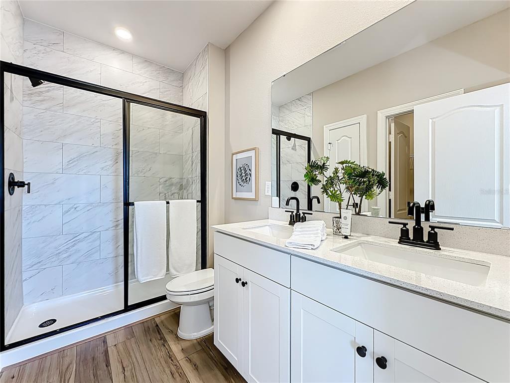 3941 Gareys Ferry Way Middleburg, FL 32068 - Photo 19 of 45 a bathroom with a sink a toilet and a large mirror