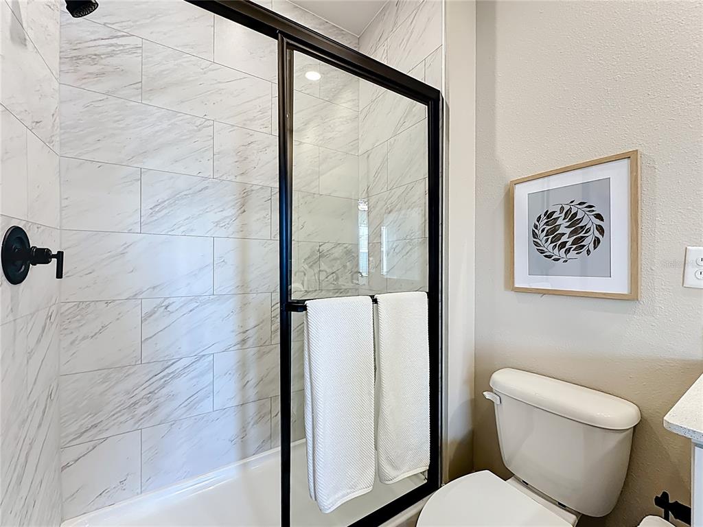 3941 Gareys Ferry Way Middleburg, FL 32068 - Photo 20 of 45 a bathroom with a toilet and a shower