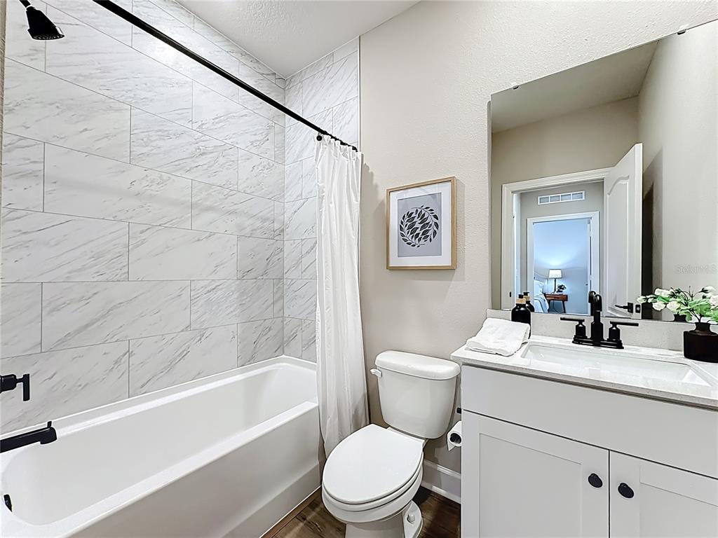 3941 Gareys Ferry Way Middleburg, FL 32068 - Photo 21 of 45 a bathroom with a sink a toilet and a bathtub