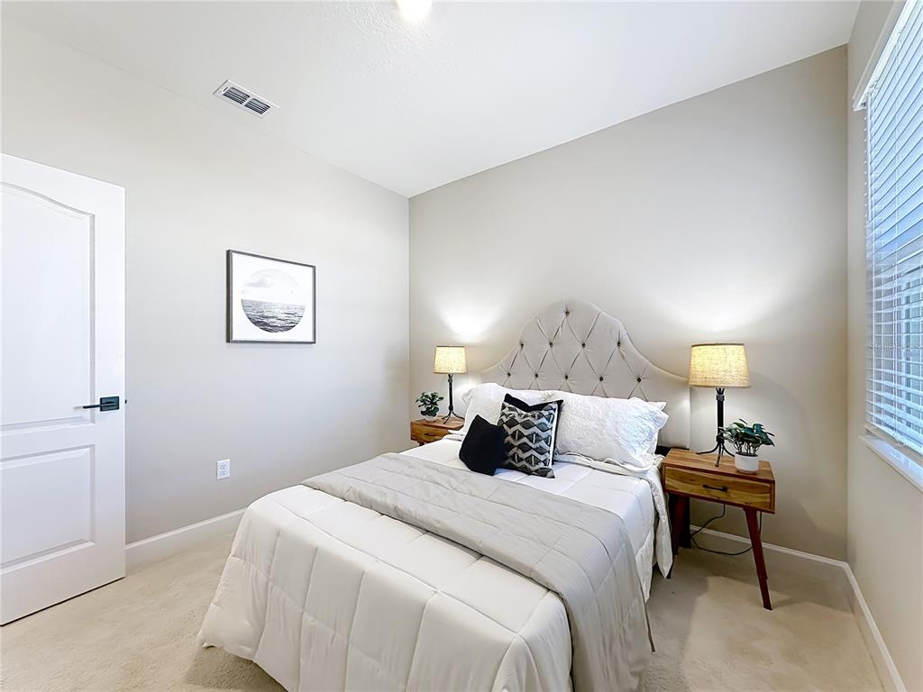 3941 Gareys Ferry Way Middleburg, FL 32068 - Photo 27 of 45 a bedroom with a bed and a painting on the wall