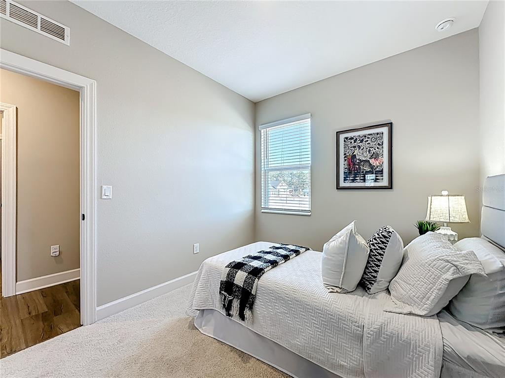 3941 Gareys Ferry Way Middleburg, FL 32068 - Photo 30 of 45 a bedroom with a bed and painting on the wall