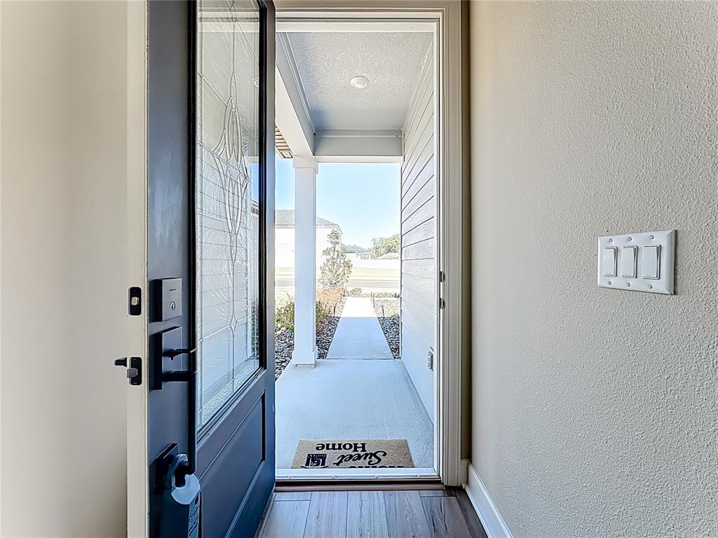 3941 Gareys Ferry Way Middleburg, FL 32068 - Photo 3 of 45 a view of a hallway with wooden floor and a living room