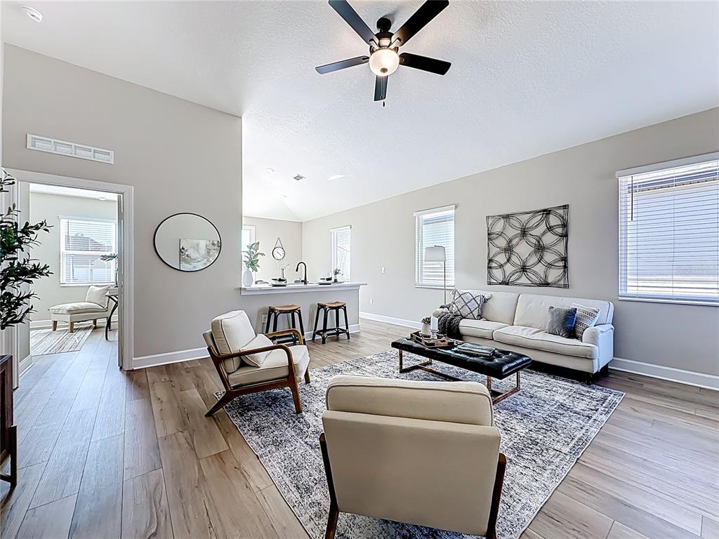 3941 Gareys Ferry Way Middleburg, FL 32068 - Photo 6 of 45 a living room with furniture and a wooden floor