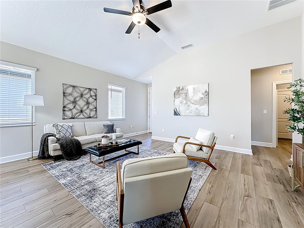 3941 Gareys Ferry Way Middleburg, FL 32068 - Photo 7 of 45 a living room with furniture and a wooden floor
