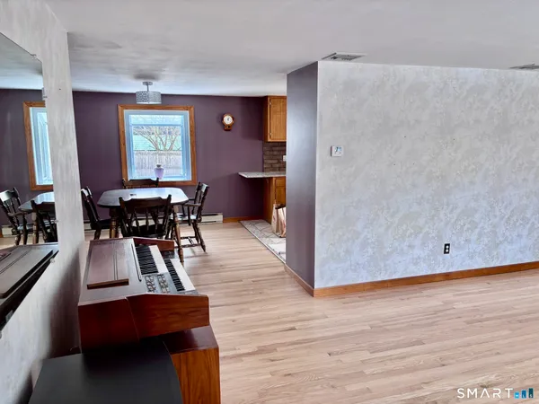 a view of a dining room with furniture and wooden floor