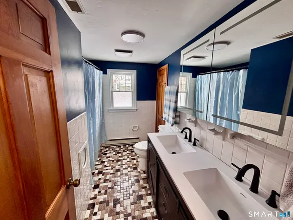 a bathroom with a sink a mirror and shower