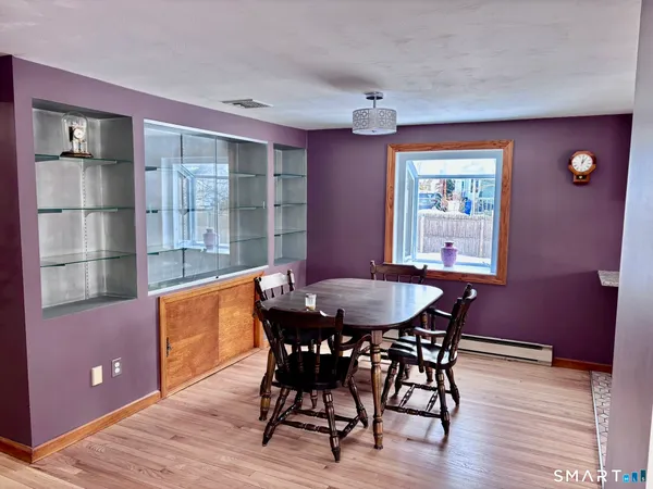 a view of a dining room with furniture and window