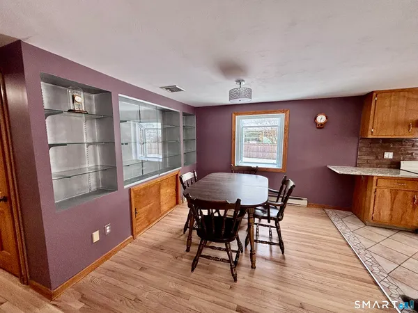 a view of a dining room with furniture window and wooden floor