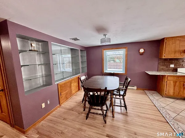a view of a dining room with furniture window and wooden floor
