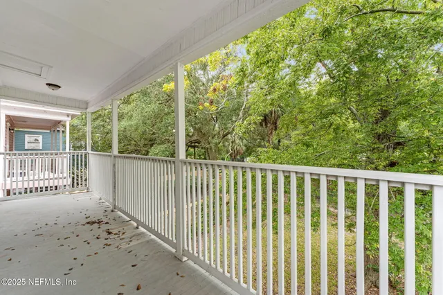 a view of a wooden deck and a yard